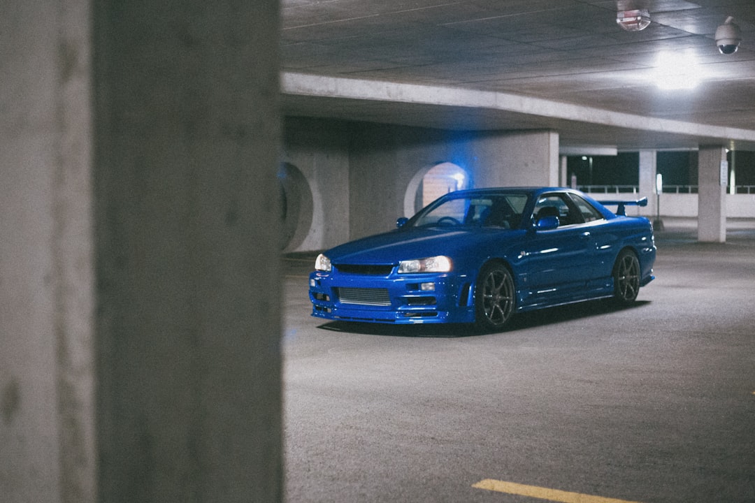 blue bmw m 3 coupe parked on parking lot during daytime