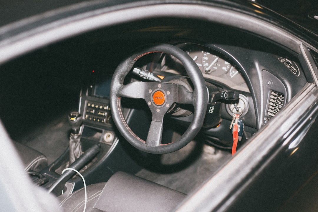black car steering wheel and red coated wire