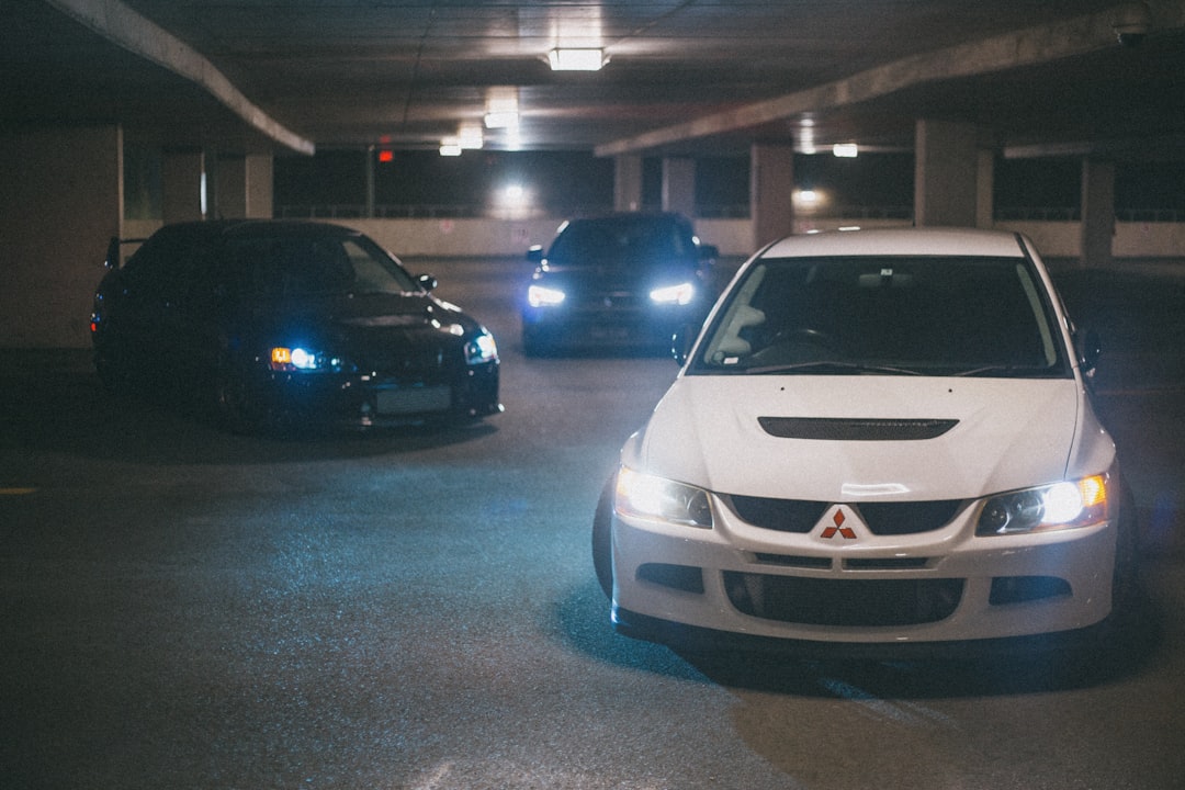 white honda car parked on parking lot during night time