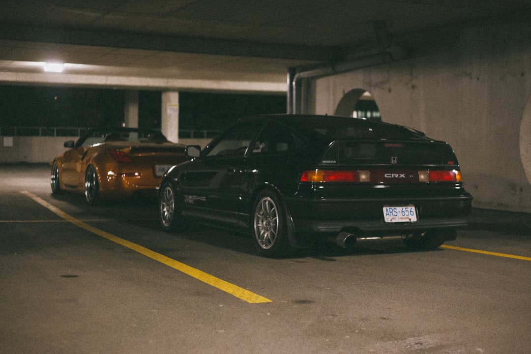 black sedan parked on parking lot during daytime