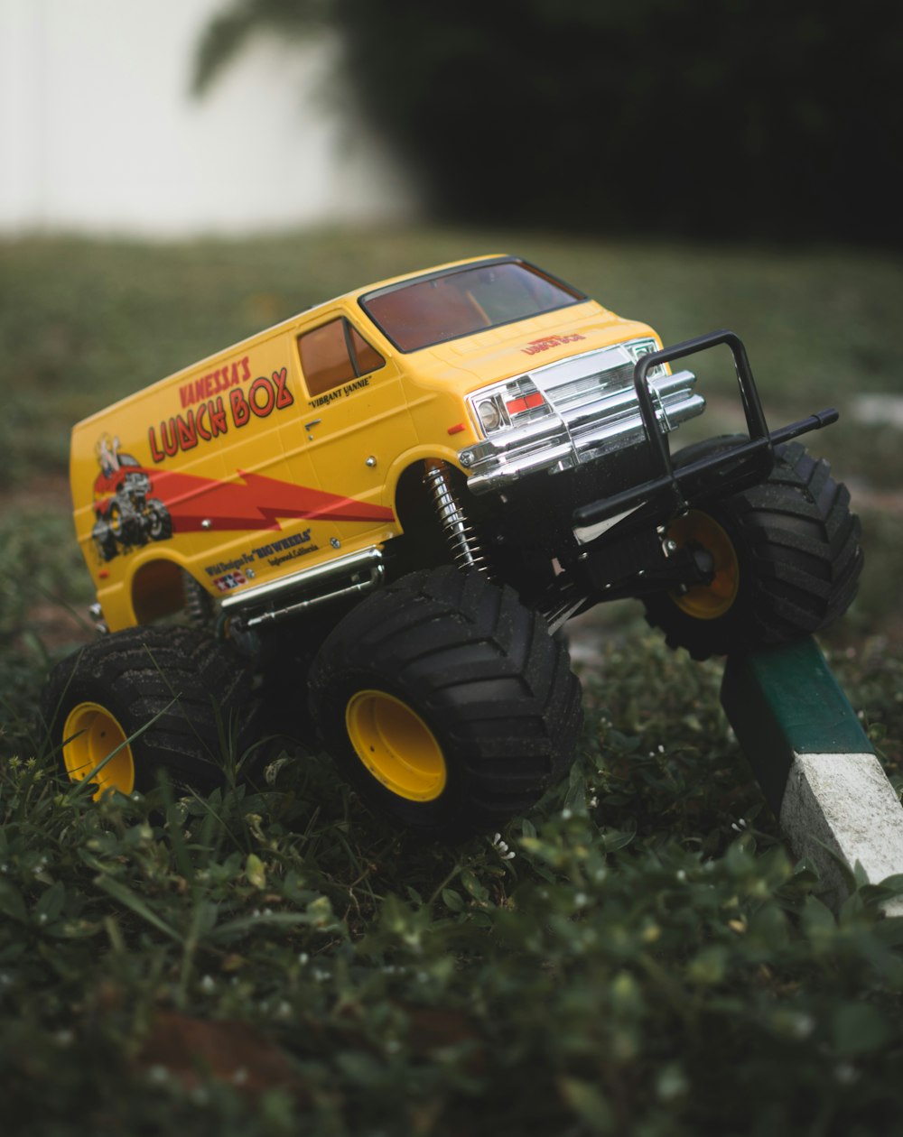 yellow and black truck toy on green grass