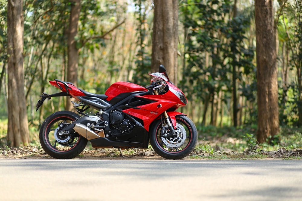 red and black sports bike on road during daytime