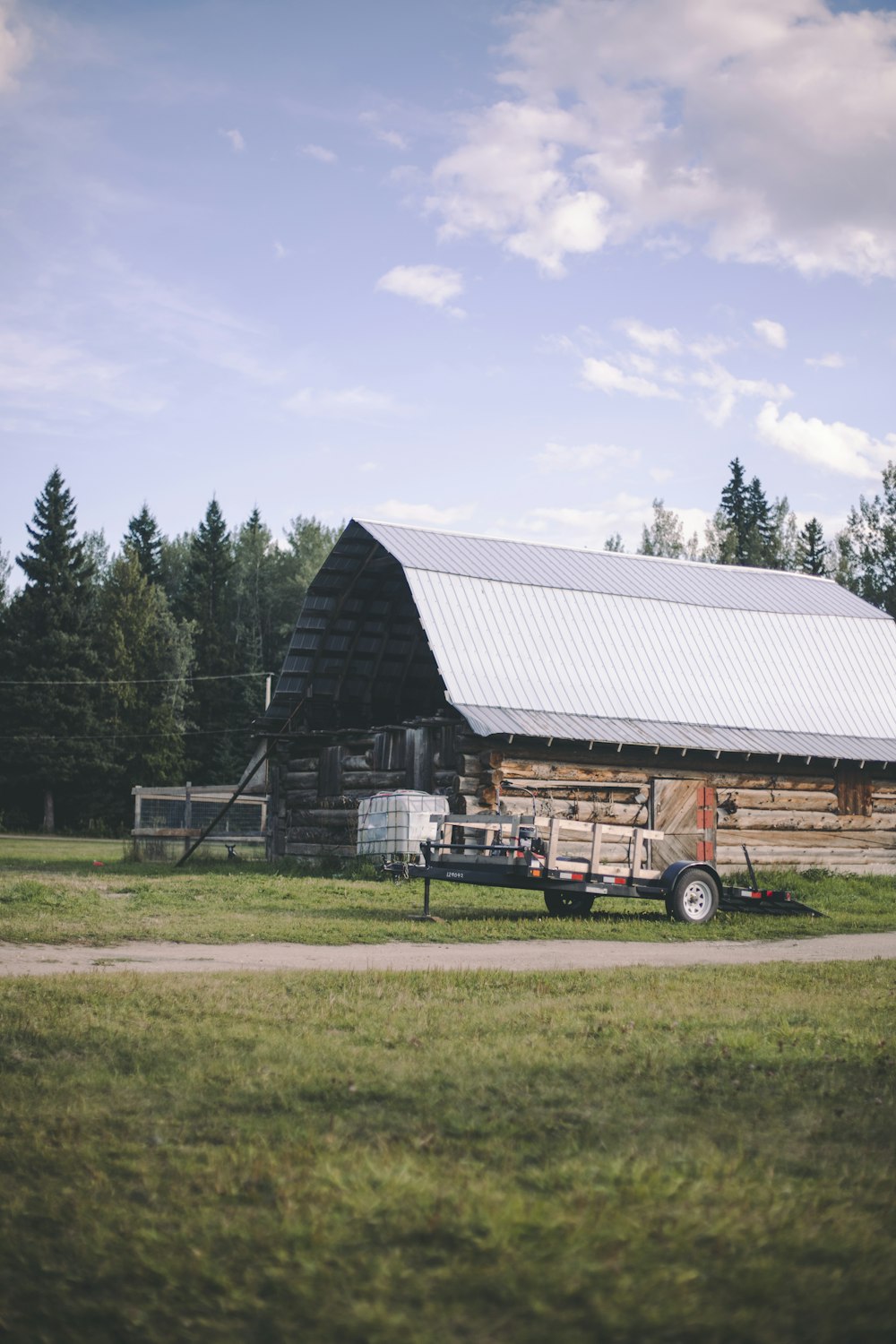 a truck parked in front of a barn