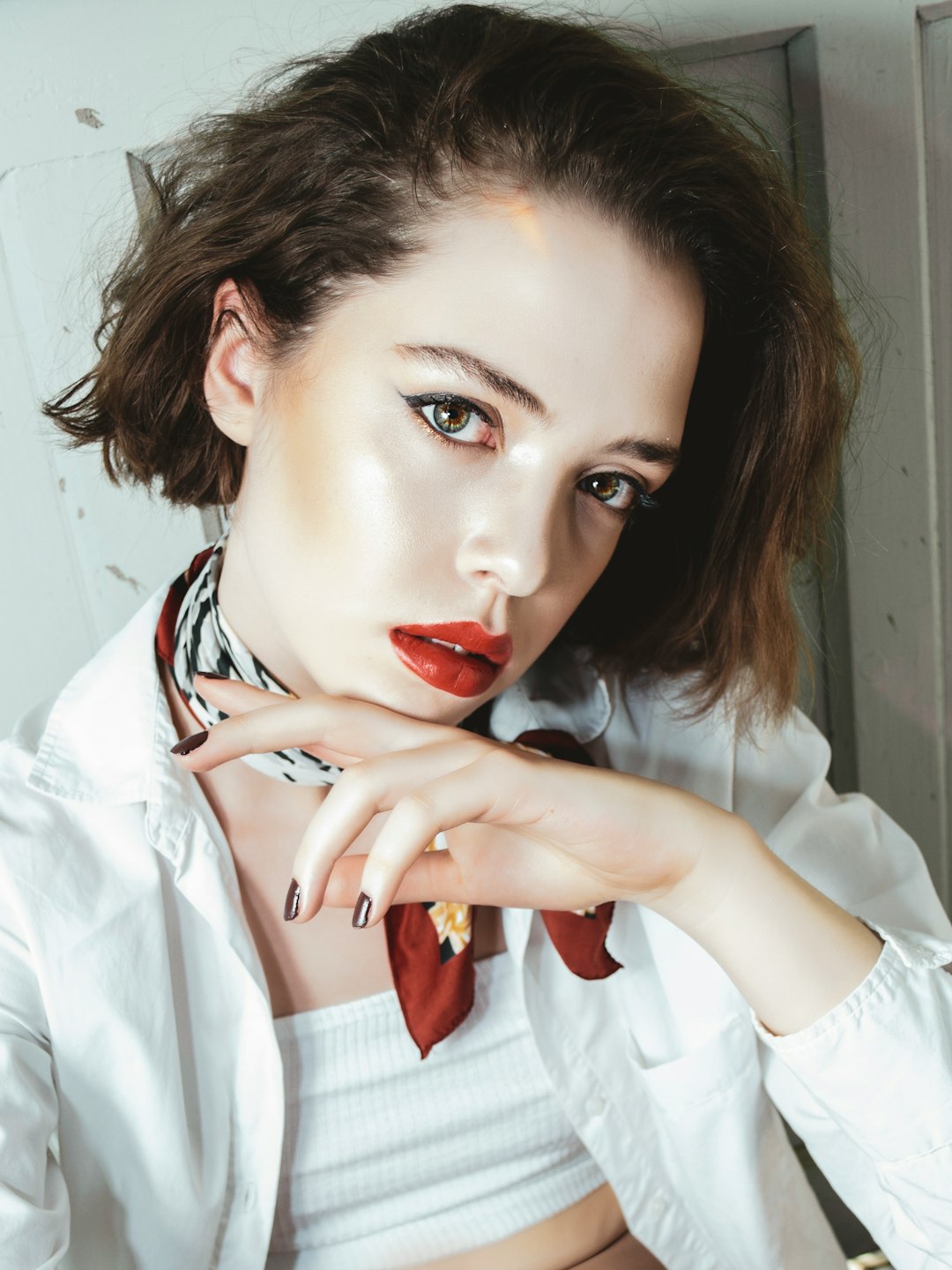 woman in white long sleeve shirt with red lipstick