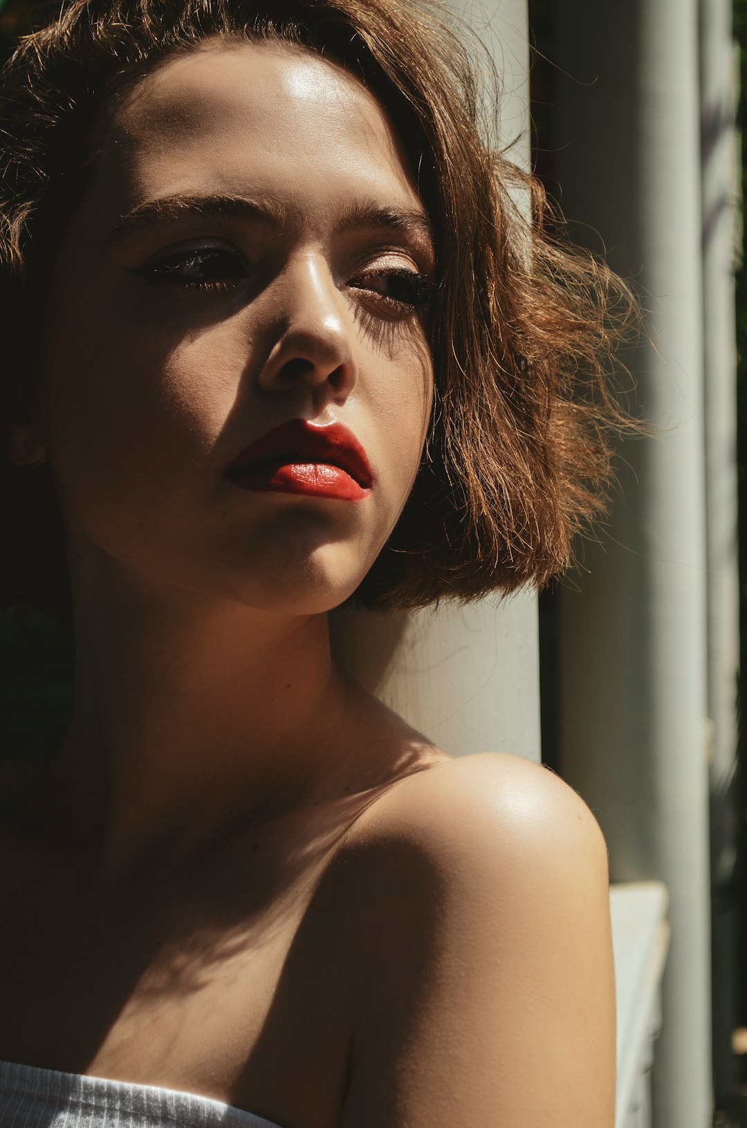 woman in red lipstick and black mascara