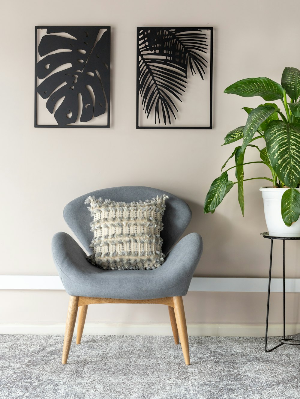 gray and white throw pillow on gray armchair