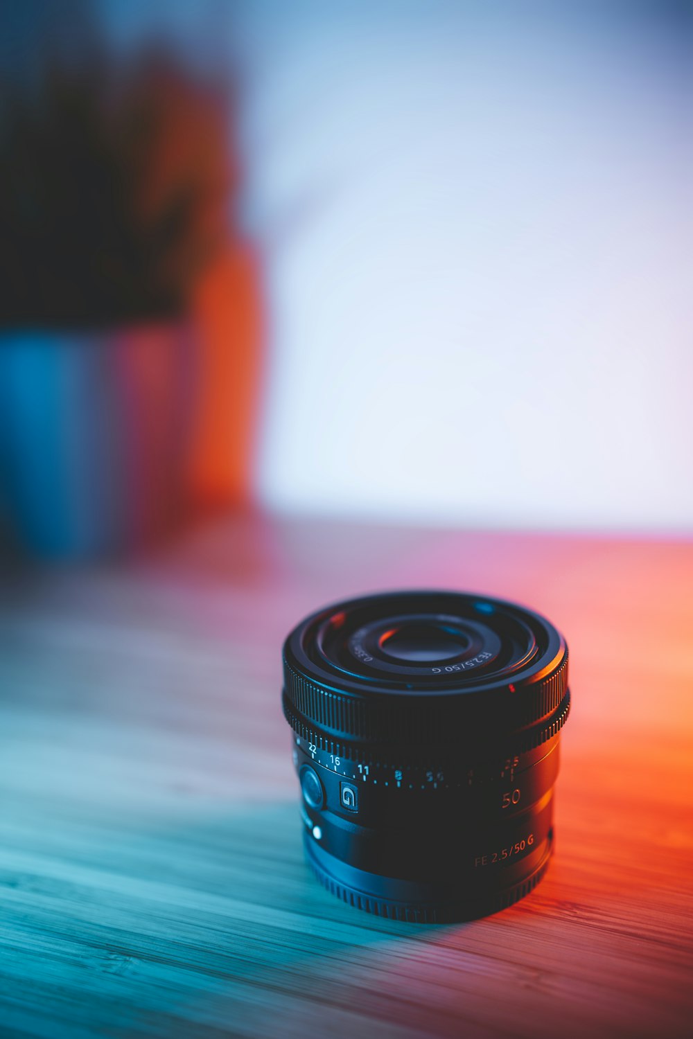 black camera lens on blue table