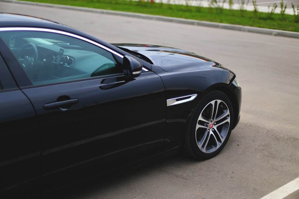 black car on gray asphalt road during daytime