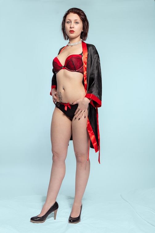 woman in red bikini standing onlyfans agency