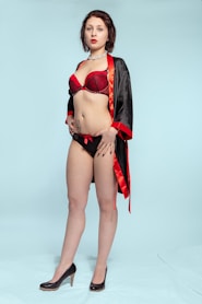 woman in red bikini standing onlyfans agency