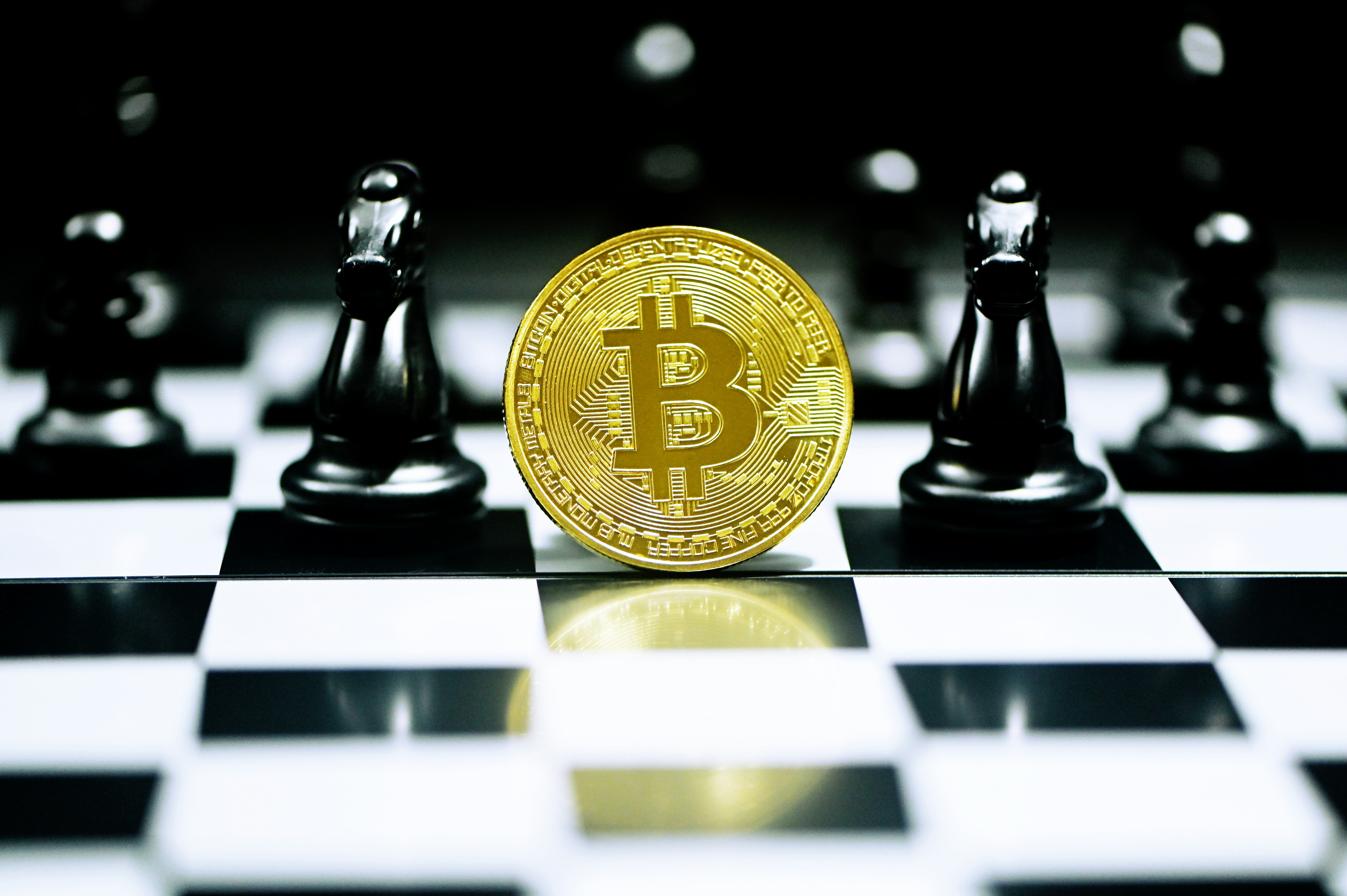 A single Bitcoin stands on a chess board