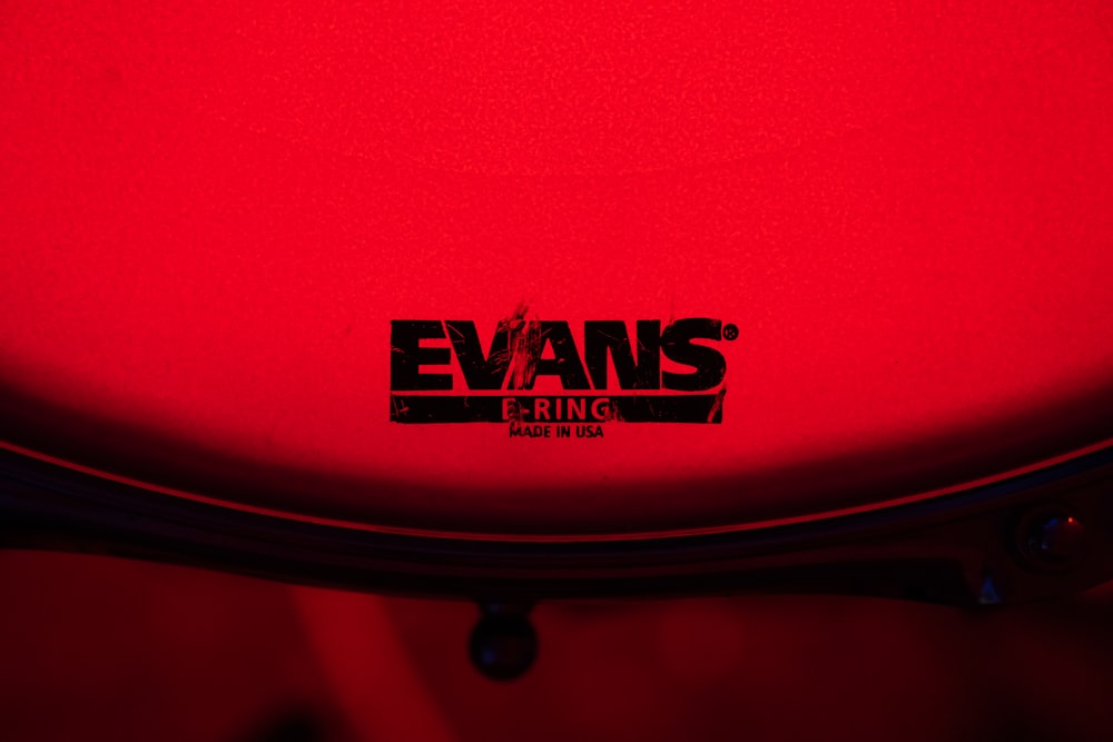 a close up of a red frisbee with the name evans on it