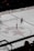 An ice hockey match is underway in an arena with players in jerseys and an official in black and white stripes visible. The center of the rink features a large star emblem with Russian text around it. Advertisements in Cyrillic script are displayed on the boards surrounding the rink.