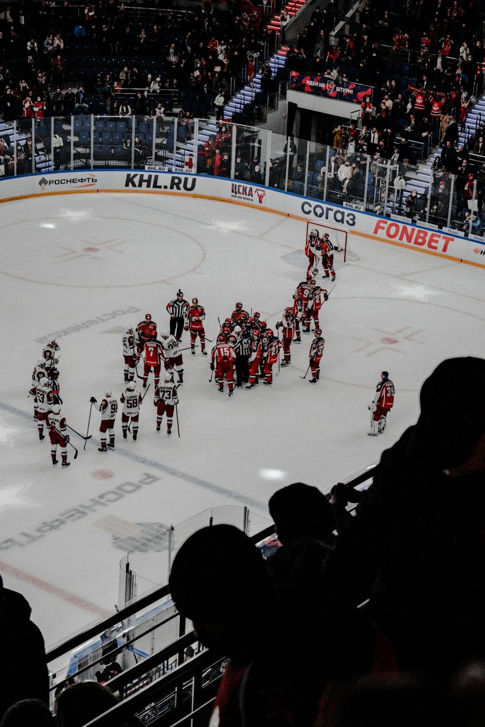 people playing ice hockey on ice field