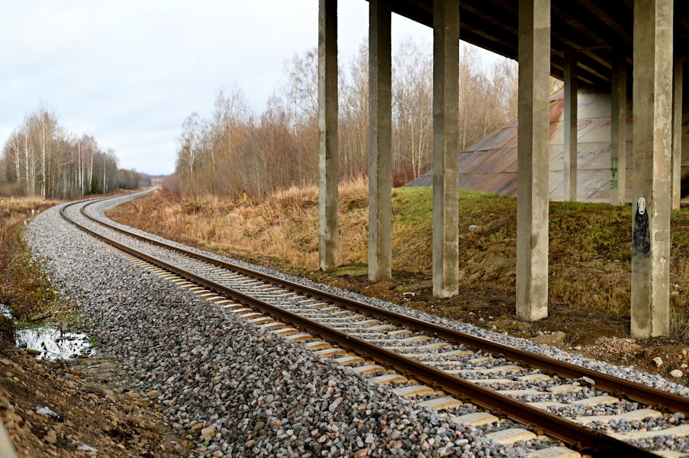 brown wooden posts on train rail during daytime