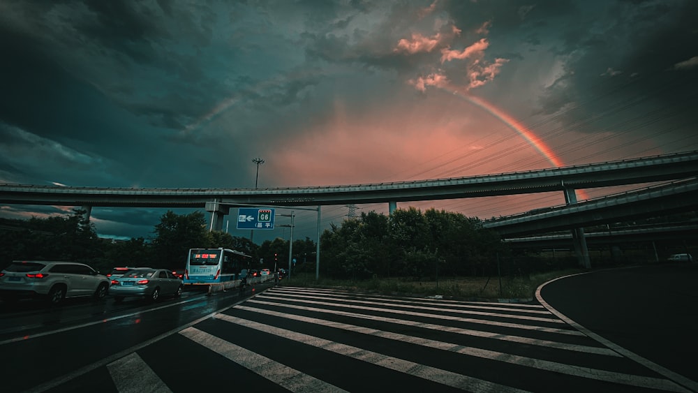 cars on road under cloudy sky during daytime