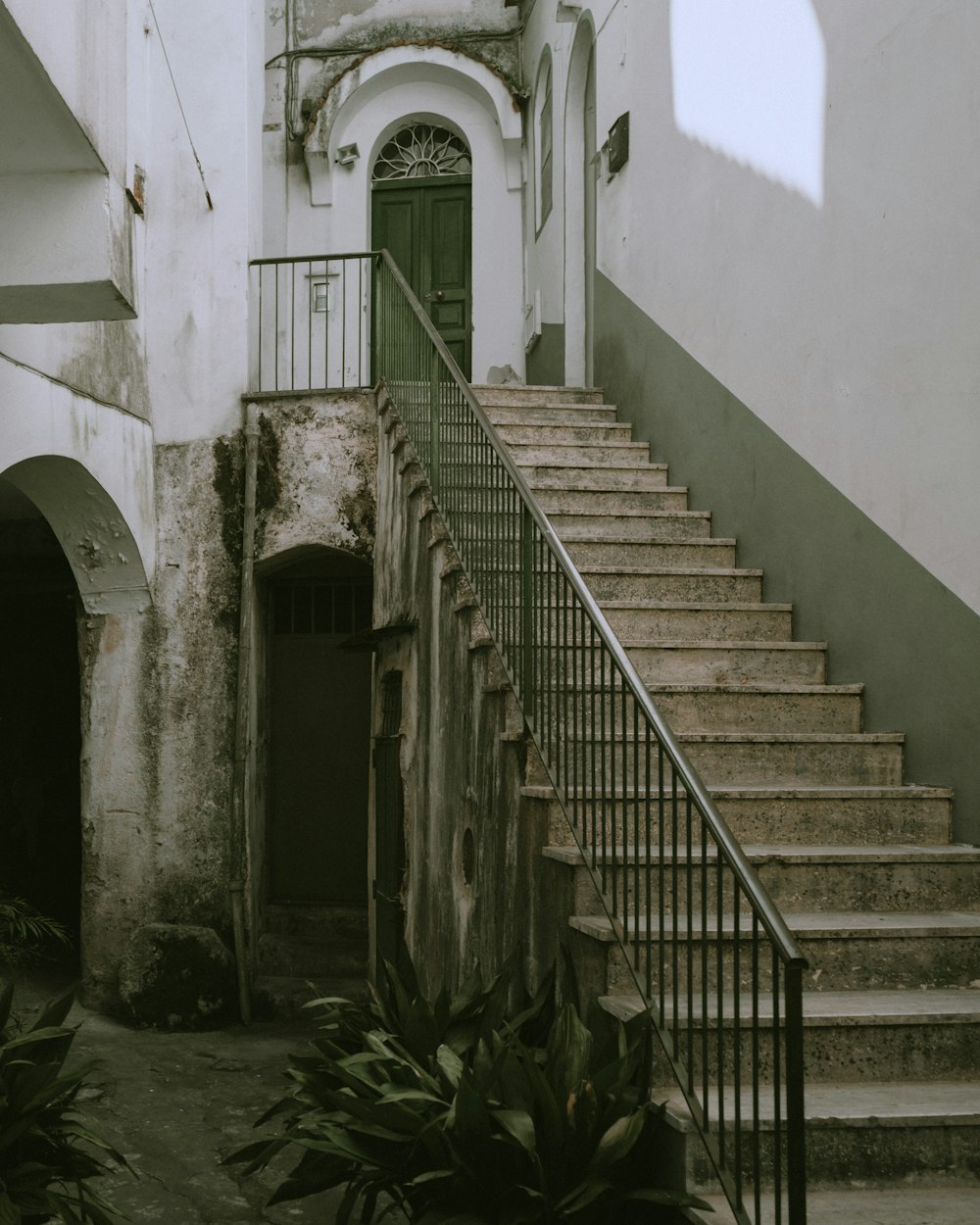 black metal staircase near white concrete building