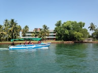 Close-up of passengers smiling aboard a modern speedboat with life vests on.