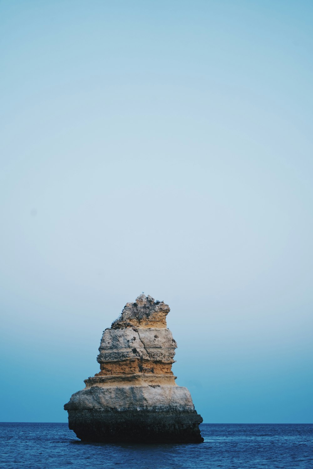 brown rock formation under white sky during daytime