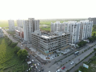Modern construction site with workers and green management branding in Ho Chi Minh City.