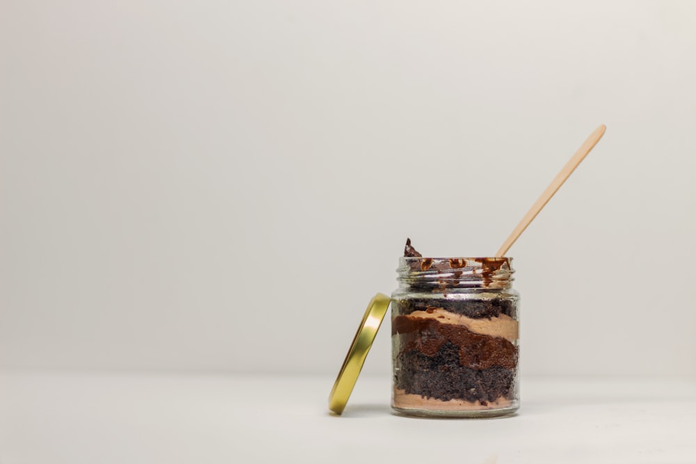 clear glass jar with brown powder