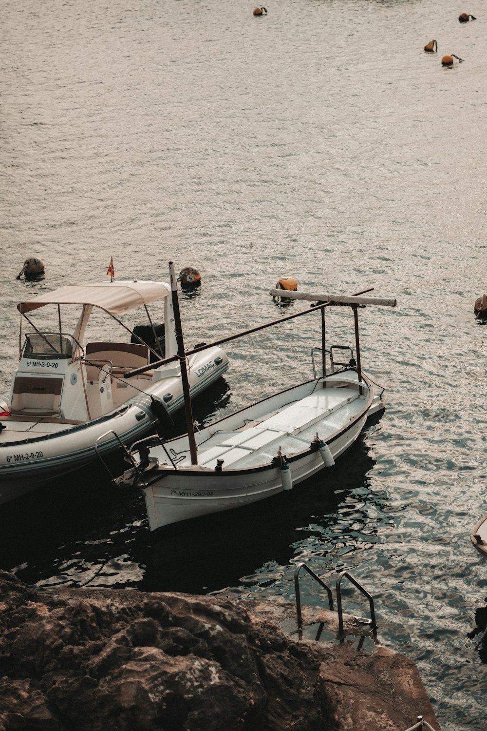 white and black boat on sea during daytime