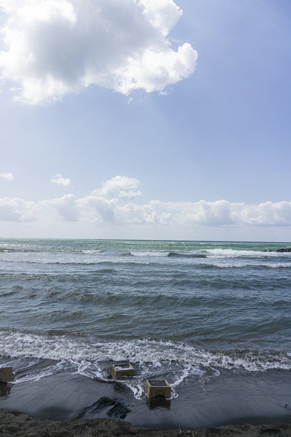 blue sea under blue sky and white clouds during daytime