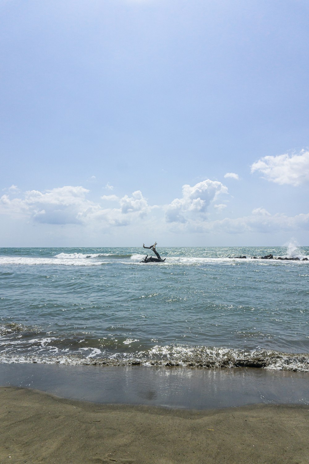 person surfing on sea waves during daytime