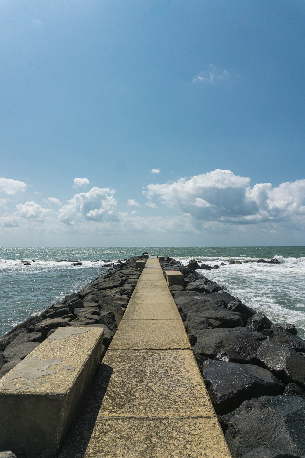 gray concrete dock near body of water during daytime