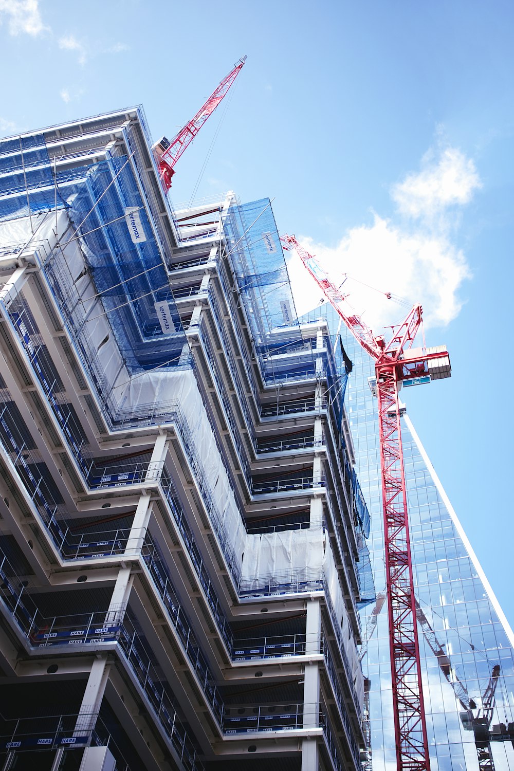 red crane in front of building