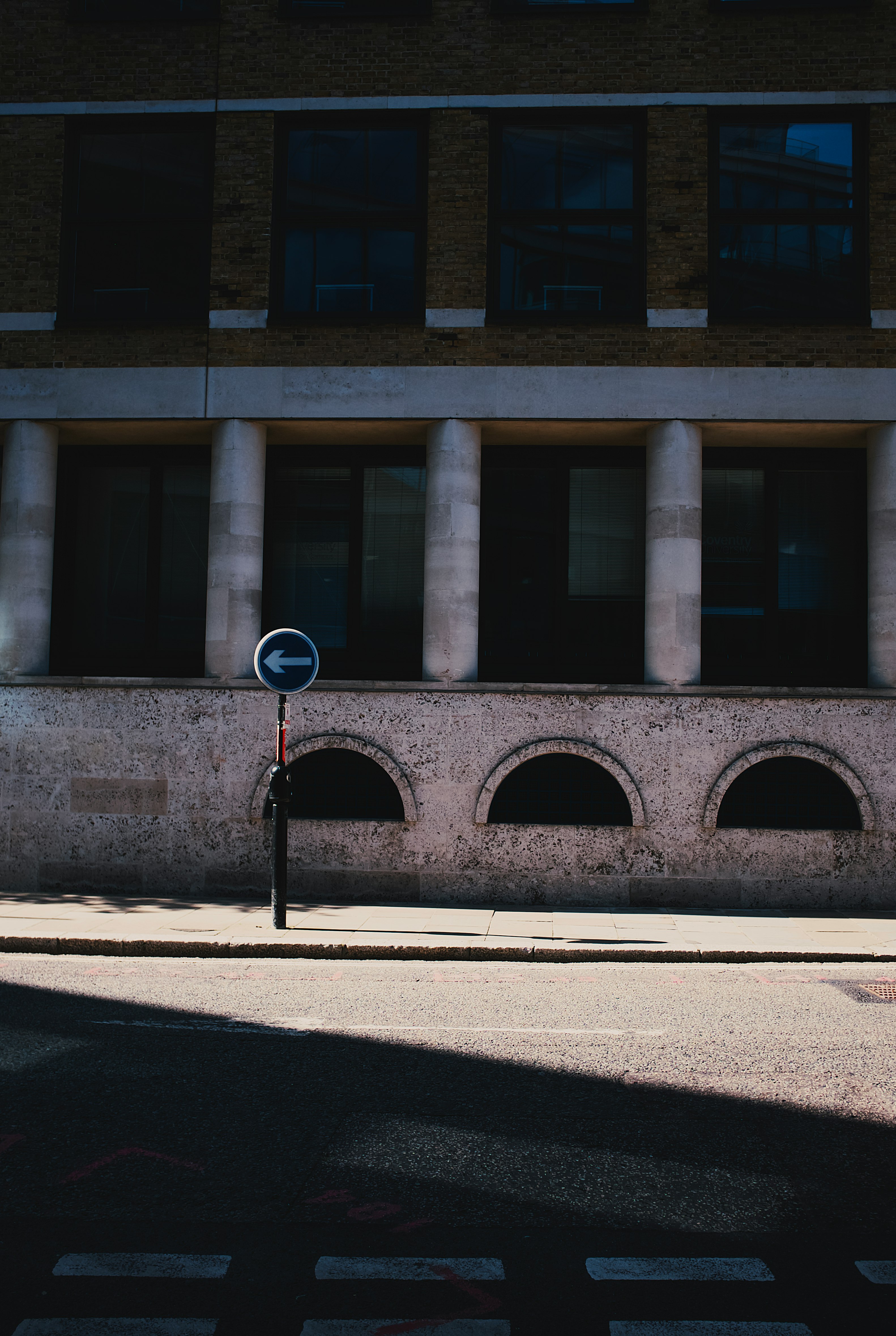 black street light near brown concrete building during daytime