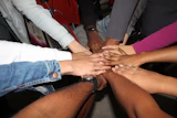 team stacking hands together in unity