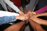 team stacking hands together in unity