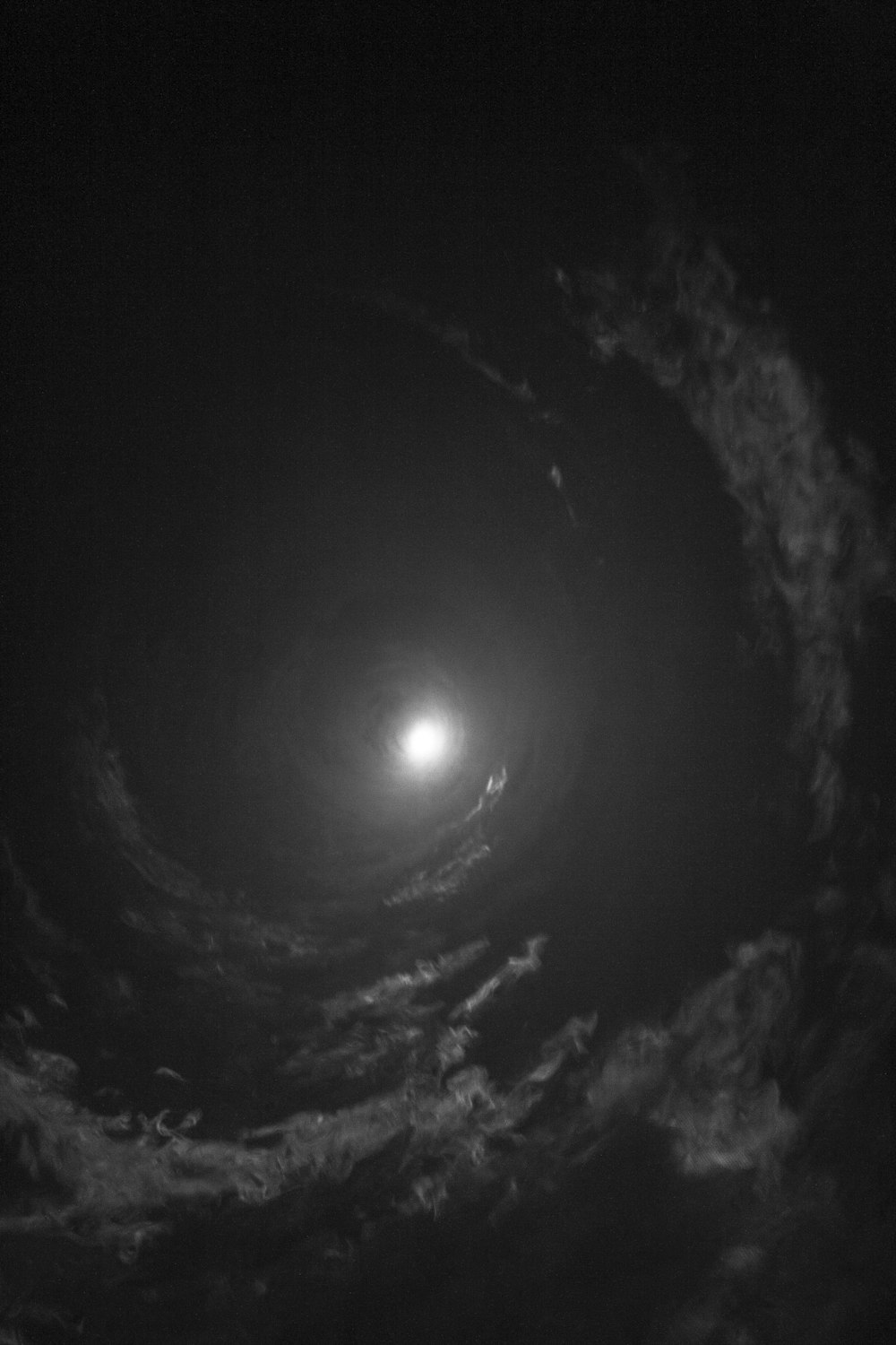 grayscale photo of moon in the sky