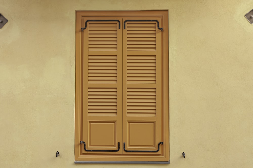 brown wooden door with black steel handle