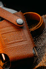 brown leather bag on gray textile