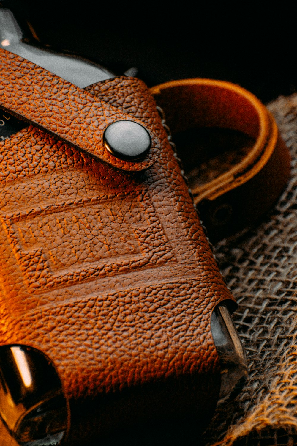 brown leather bag on gray textile