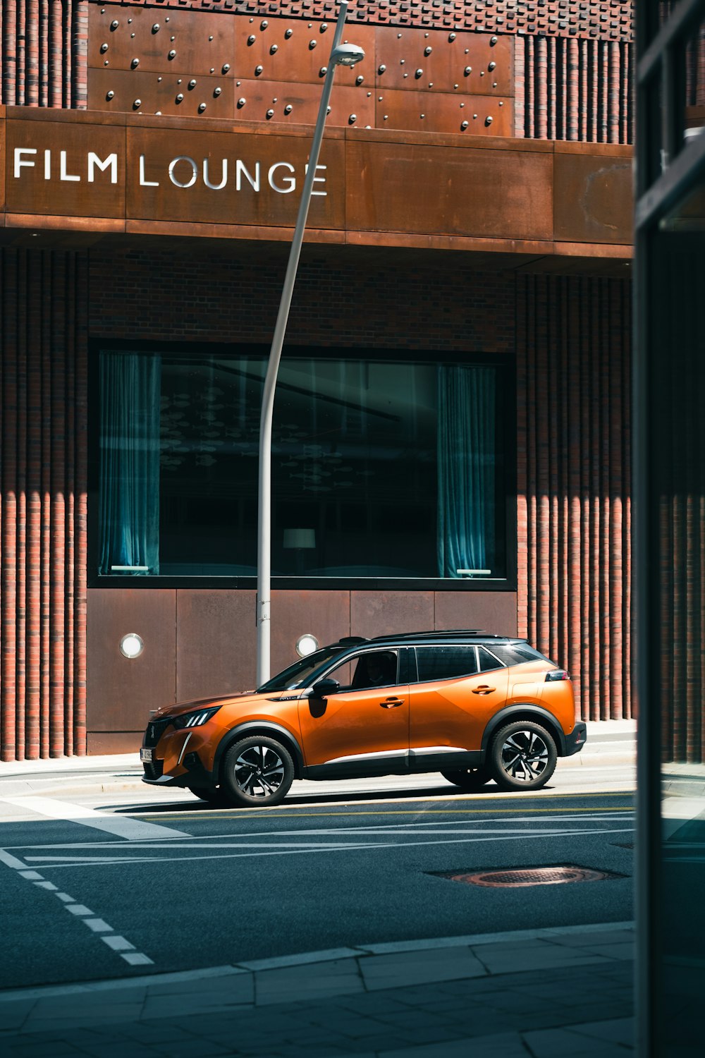 orange mini cooper parked beside brown building during daytime