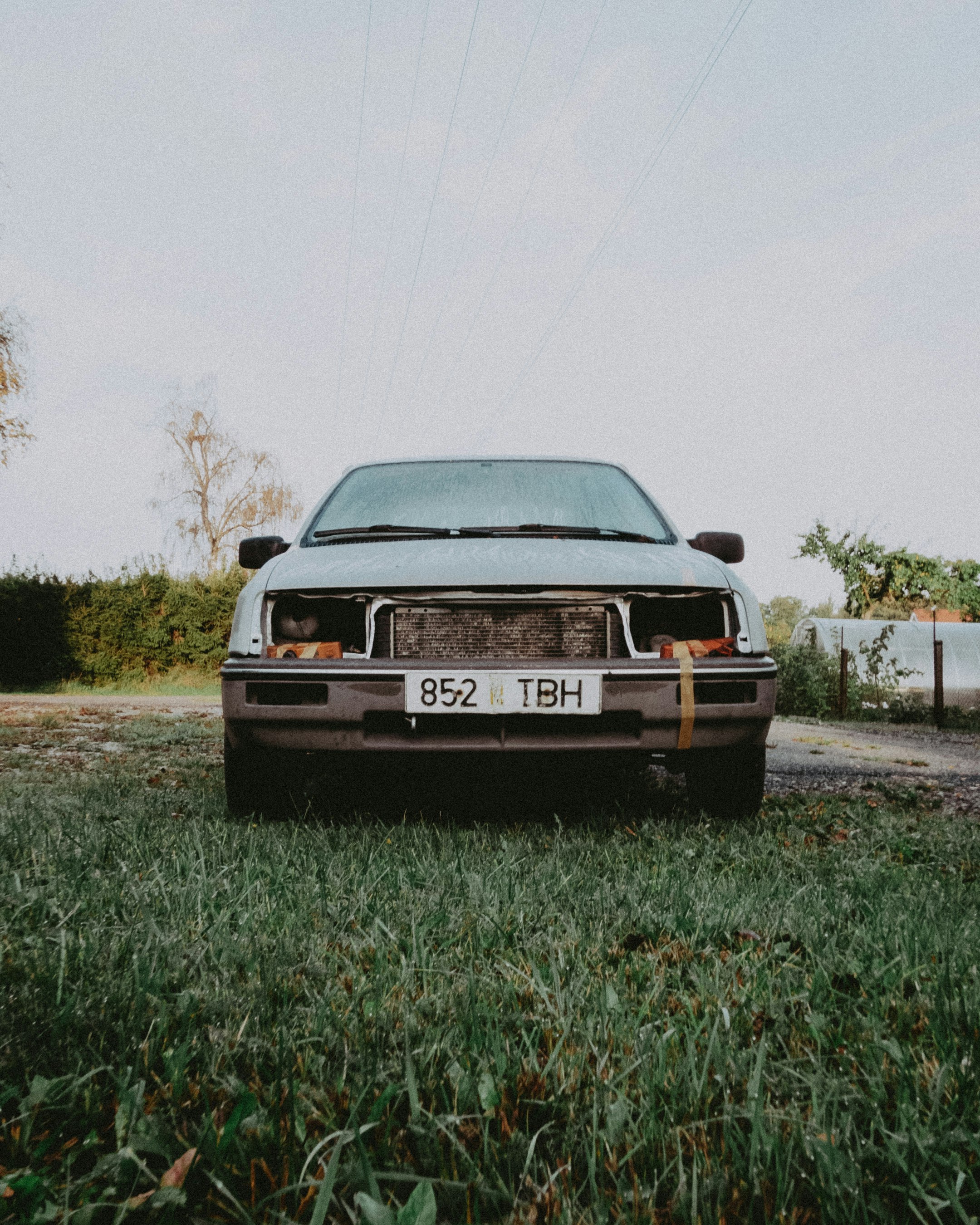 black car parked on green grass field during daytime