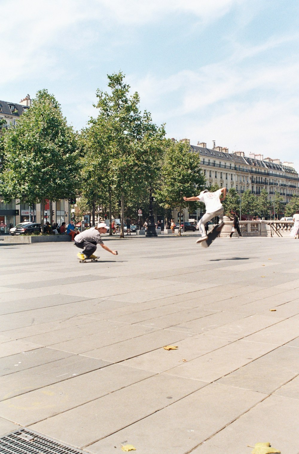 man in white shirt and black pants riding on black motorcycle on gray concrete road during