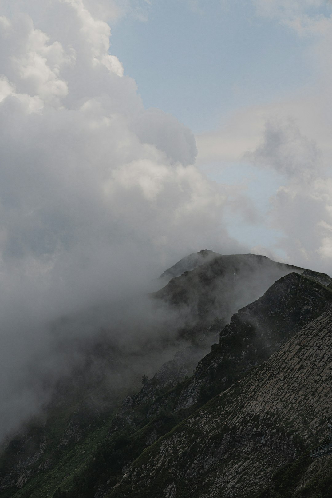 green mountain under white clouds during daytime