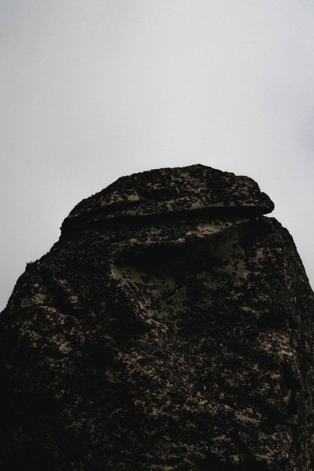 brown rock formation under white sky during daytime