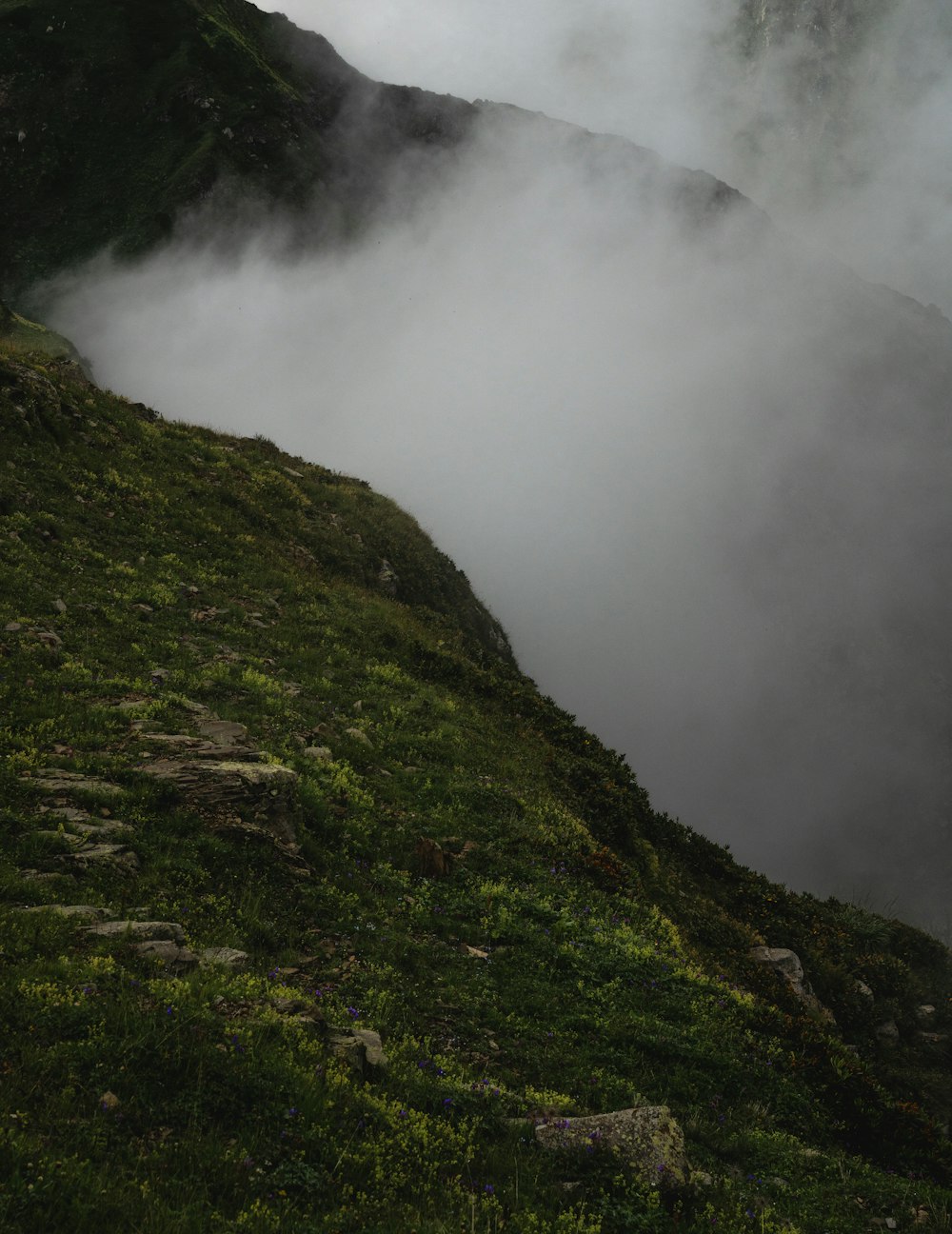 green mountain under white clouds during daytime