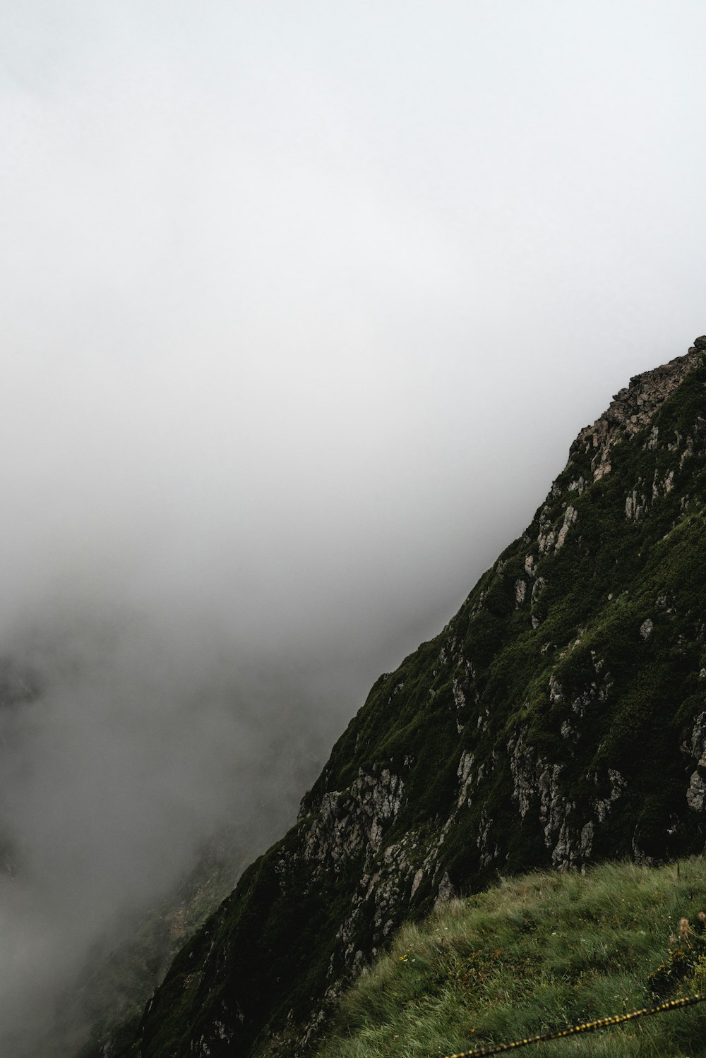 green and black mountain under white sky