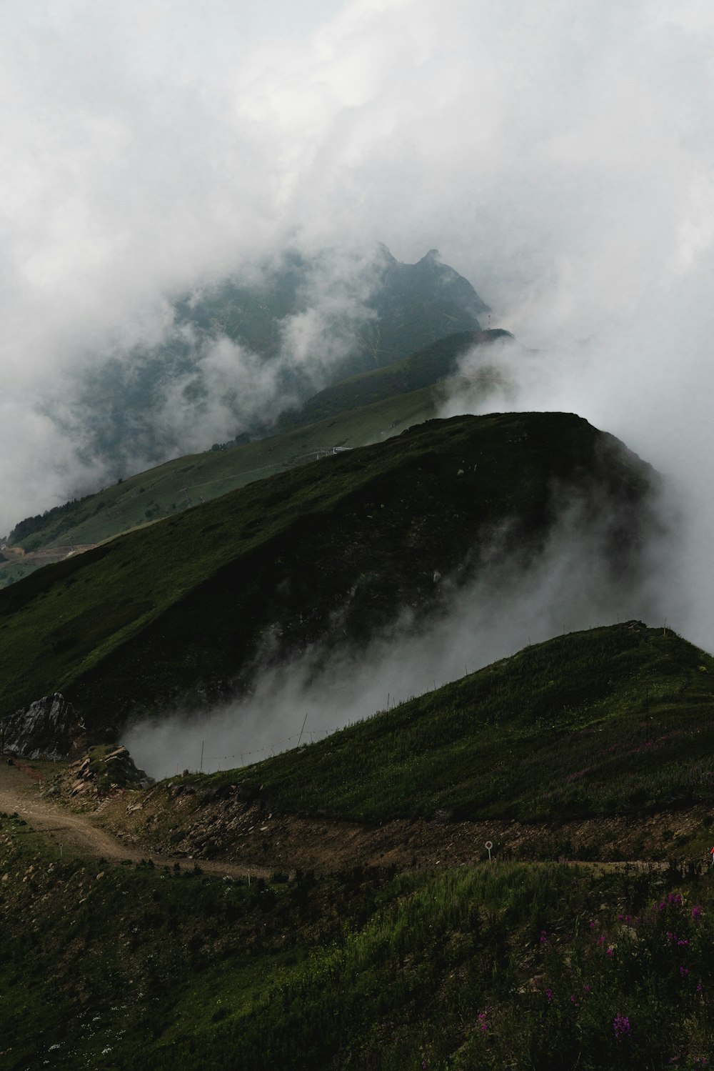 green mountain under white clouds during daytime