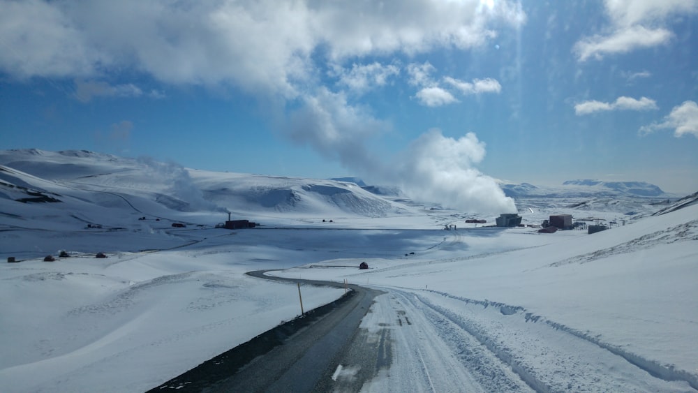 snow covered field under blue sky during daytime