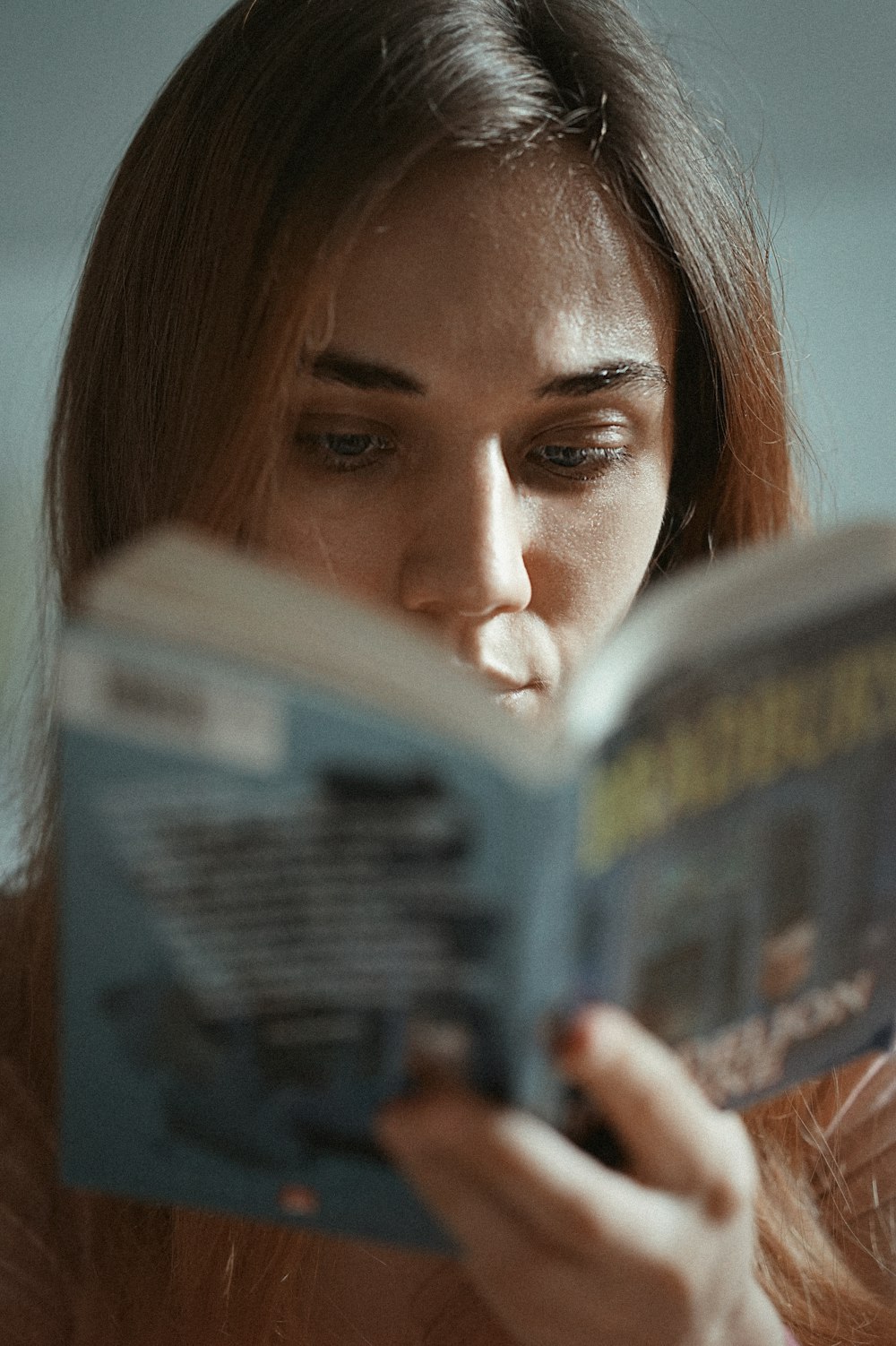 woman holding magazine with womans face