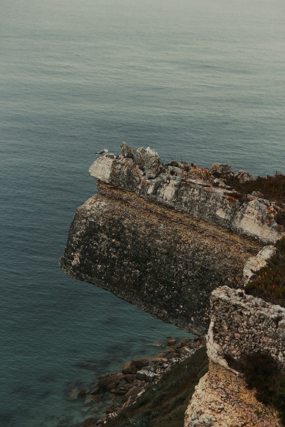 brown rock formation on sea during daytime