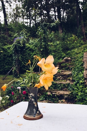 Elegant ceramic vase holding a bouquet of ceramic flowers.