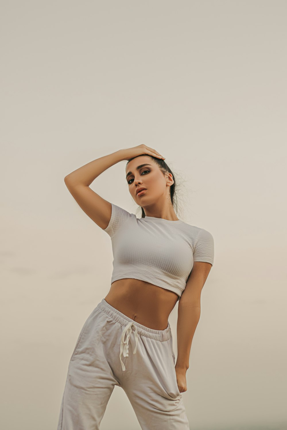 woman in white crop top and white skirt